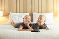 Sweet little brother and sister watching tv on a bed Royalty Free Stock Photo