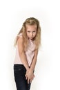 Sweet little child girl with beautiful blonde hair in casual clothes looking shy and timid as if scared Royalty Free Stock Photo