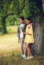 Little boy giving bouqet of flowers to girl.