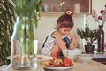 Sweet little cute girl learns to cook a meal in the kitchen. Royalty Free Stock Photo