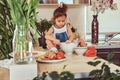 Sweet little cute girl learns to cook a meal in the kitchen. Royalty Free Stock Photo