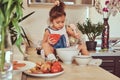 Sweet little cute girl learns to cook a meal in the kitchen. Royalty Free Stock Photo