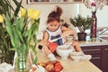 Sweet little cute girl learns to cook a meal in the kitchen. Royalty Free Stock Photo