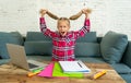 Sweet little elementary school girl pulling her blonde hair in stress getting crazy while trying to study and doing homework at Royalty Free Stock Photo
