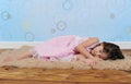 Sweet little girl asleep on furry brown rug Royalty Free Stock Photo