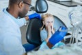 Sweet little girl being scared of dental drill Royalty Free Stock Photo