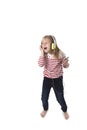 Sweet little girl with blonde hair listening to music with headphones and mobile phone singing and dancing happy Royalty Free Stock Photo