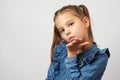 Sweet little girl blowing kisses, wearing a denim dress Royalty Free Stock Photo