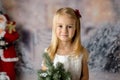 Sweet little girl with christmas decorations, playing Royalty Free Stock Photo