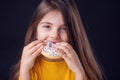 Sweet little girl eating white donut portrait