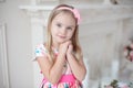 Sweet little girl holding her hands under her chin Royalty Free Stock Photo