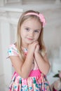 Sweet little girl holding her hands under her chin Royalty Free Stock Photo