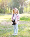 Sweet little girl with old vintage retro camera outdoors Royalty Free Stock Photo