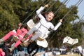 Sweet little girl riding on carousel Festival