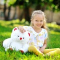 Sweet little girl with toy bear outdoor Royalty Free Stock Photo