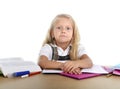 Sweet little school girl tired and sad in stress with books and homework Royalty Free Stock Photo