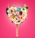 Sweet Lolipop in Heart form of whipped cream with sweets, jellies, heart front view. Crazy freakshake food trend. Front