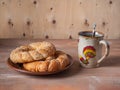 Sweet lunch with fresh pastries and green tea in a large ceramic mug