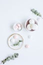 Sweet lunch with marsh-mallow and spring flowers for woman on white background top view