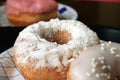 Sweet lush donuts with white powdered sugar closeup. Selective focus