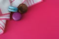 Sweet macarons. Colorful bisquits. Top view. Copy text space. Hot pink background. Table cloth. Royalty Free Stock Photo