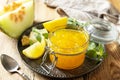 Sweet melon and citrus jam or jelly in small glass jar with fresh melon slices on wooden rustic table. Homemade preserve Royalty Free Stock Photo