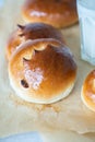 Sweet milk buns with raisins on a baking paper, overhead view Royalty Free Stock Photo