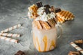 Sweet milkshake drink with dripping sauce, cream, cake and chocolate Royalty Free Stock Photo