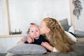 Sweet moment between a big sister and her baby brother. The sister is kissing his cheek. Love sisters. parental care and Royalty Free Stock Photo