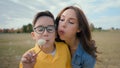 Sweet moment happy Caucasian family single parent mother hug embrace little boy son kid child blow dandelion flower seed Royalty Free Stock Photo