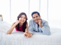 The sweet moment of happy couple lover lying on the white bed. Royalty Free Stock Photo