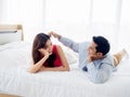 The sweet moment of happy couple lover lying on the white bed. Royalty Free Stock Photo