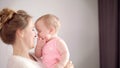 Sweet mother with little baby on hands. Cheerful woman smile to kid girl Royalty Free Stock Photo