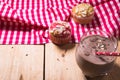 Sweet muffins with almond on wooden table.