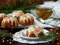 Sweet muffins decorated fondant, multicolored sprinkles. Cupcakes on dark background with spruce branches. Christmas and New Year