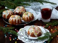 Sweet muffins decorated fondant, multicolored sprinkles. Cupcakes on dark background with spruce branches. Christmas and New Year