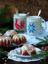 Sweet muffins decorated fondant, multicolored sprinkles. Cupcakes on dark background with spruce branches. Christmas and New Year