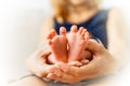 Sweet newborn baby`s feet in woman`s arms Royalty Free Stock Photo