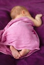 Sweet newborn baby sleeping in the bed with pink blanket Royalty Free Stock Photo
