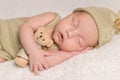 Sweet newborn baby sleeping in costume and hat