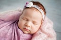 Sweet newborn baby sleeping.  Newborn girl 3 weeks old lying in a basket with knitted plaid. Portrait of pretty  newborn girl. Royalty Free Stock Photo