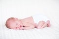 Sweet newborn baby sleeping wearing a diaper
