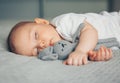 Sweet newborn baby sleeps with a gray toy hare Royalty Free Stock Photo