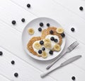 Sweet oatmeal pancakes with cream, blueberry and banana. Healthy Breakfast concept Royalty Free Stock Photo