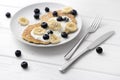 Sweet oatmeal pancakes with cream, blueberry and banana. Healthy Breakfast concept Royalty Free Stock Photo