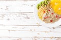 Sweet oatmeal porridge with pine nuts and fresh fruits - pear, orange, kiwi and pomegranate. Healthy dietary breakfast. Vegetarian Royalty Free Stock Photo