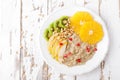 Sweet oatmeal porridge with pine nuts and fresh fruits - pear, orange, kiwi and pomegranate. Healthy dietary breakfast. Vegetarian Royalty Free Stock Photo