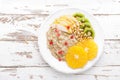 Sweet oatmeal porridge with pine nuts and fresh fruits - pear, orange, kiwi and pomegranate. Healthy dietary breakfast. Vegetarian Royalty Free Stock Photo