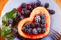 Sweet omelet with blackberries, heart-shaped