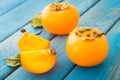 Sweet orange persimmons with green leaves